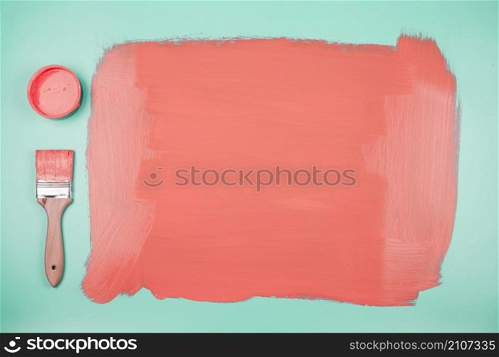 coral paint can paintbrush with painted teal background