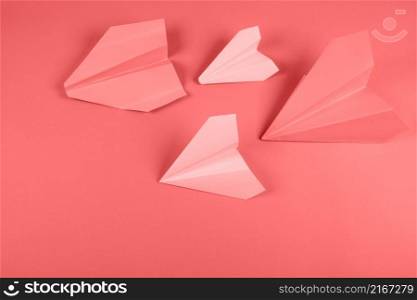 coral pink paper airplane colored background