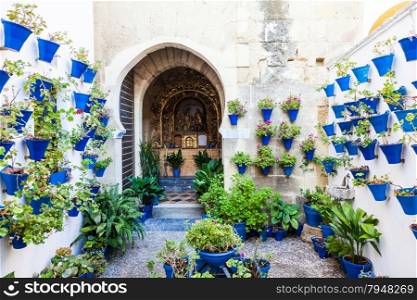 Cordoba, Andalusia Region, Spain. An old church with the traditional flowers set up of this town.