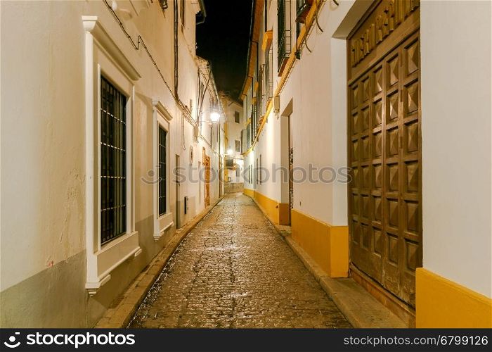 Cordoba. Old street at night.. Ancient Spanish narrow street in Cordoba at night. Andalusia.