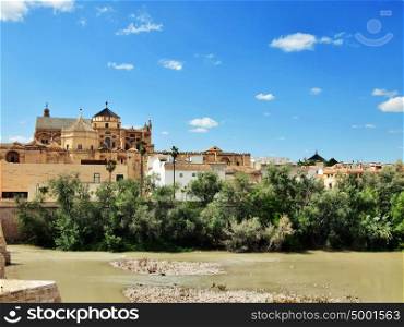 Cordoba, Spain. The Great Mosque (currently Catholic cathedral). UNESCO World Heritage Site. View with famous Roman Bridge and Guadalquivir river.