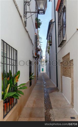 Cordoba. The old narrow city street.. Narrow street with traditional Spanish architecture in Cordoba. Spain. Andalusia.