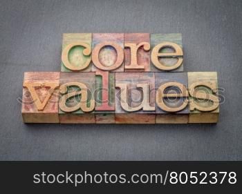 core values banner - word abstract in letterpress wood type blocks stained by color inks against a slate stone