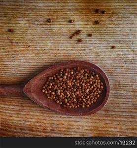 coriander seeds in wooden spoon, close up
