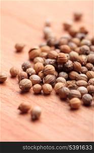 coriander seeds on wooden table close up