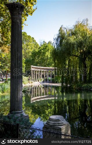 Corinthian colonnade and pond in Parc Monceau gardens, Paris, France. Corinthian colonnade in Parc Monceau, Paris, France