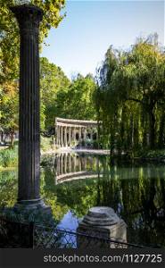 Corinthian colonnade and pond in Parc Monceau gardens, Paris, France. Corinthian colonnade in Parc Monceau, Paris, France
