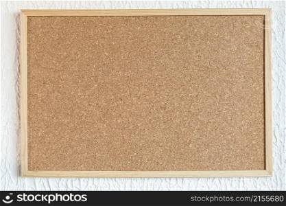 Cork board or corkboard at white painted wall background