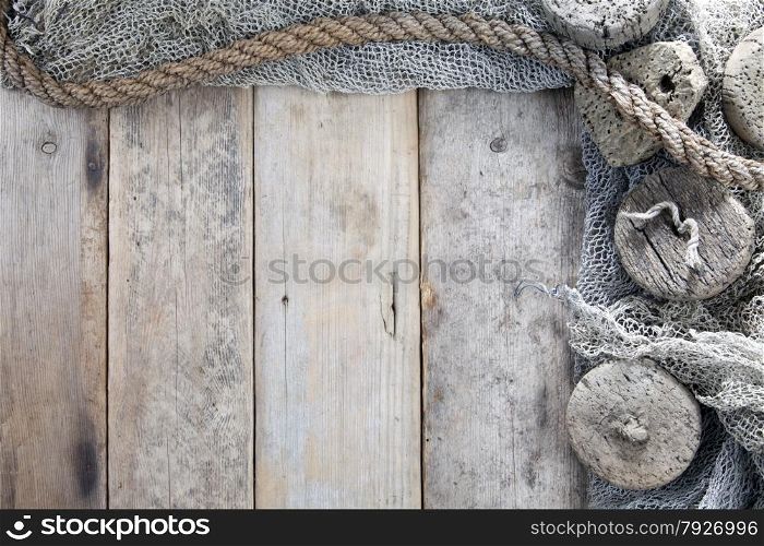 Cork, fishing net and rope with wooden background