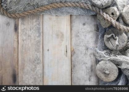 Cork, fishing net and rope with wooden background