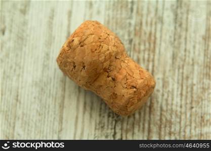 Cork from a champagne bottle on a wooden background worn