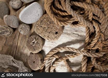 Cork, rope and stones on wooden background