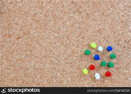 Corkboard informative without any notes and with many pins