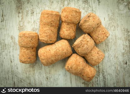 Corks from a champagne bottle on a wooden background worn