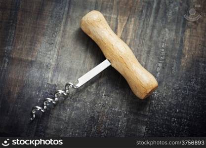Corkscrew on wooden background