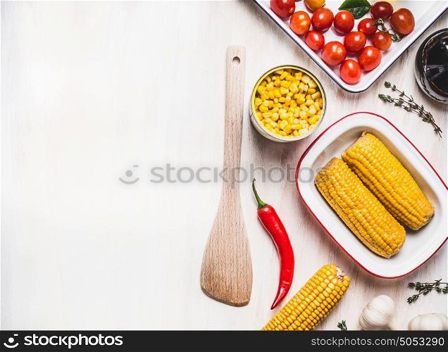 Corn cooking preparation with wooden spoon on white rustic background, top view, place for text. Healthy , clean food or vegetarian cooking and eating concept