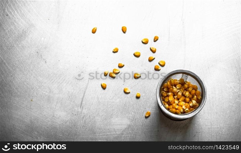 Corn for popcorn . On the metal table.. Corn for popcorn .