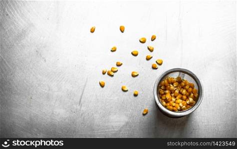 Corn for popcorn . On the metal table.. Corn for popcorn .