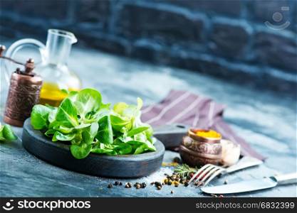corn salad on wooden board and on a table