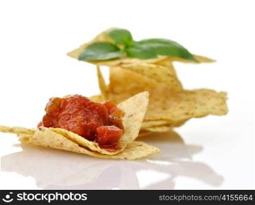 Corn tortilla chips with salsa on white background , close up