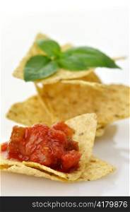 Corn tortilla chips with salsa on white background , close up