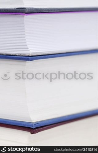 Corner of four books stacked.. Corner of four books stacked. Copy space, focus on top left pages.