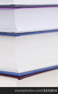 Corner of four books stacked.. Corner of four books stacked. Copy space, focus on top left pages.