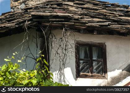 Corner with window of old weathered rural house