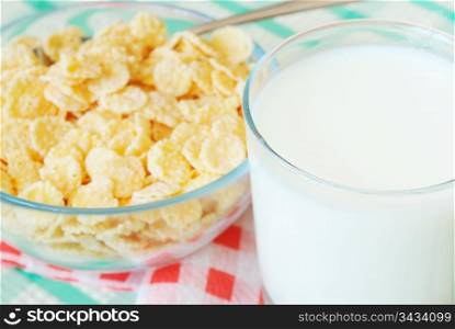 Cornflakes and milk on the table. Cornflakes and milk
