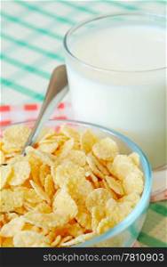 Cornflakes and milk on the table. Cornflakes and milk