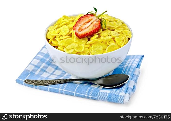 Cornflakes in a white bowl on a napkin, strawberries, spoon isolated on white background