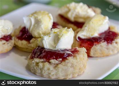 Cornish cream tea scones. Traditionally cream tea scones in Cornwall are served on a Cornish split, a sweet bread roll, with jam then cream on top.