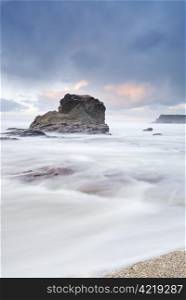 Cornish seascape shot in twilight. Motion blur in water.