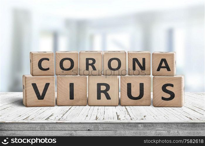 Corona virus alert message on a worn wooden desk i a bright environment