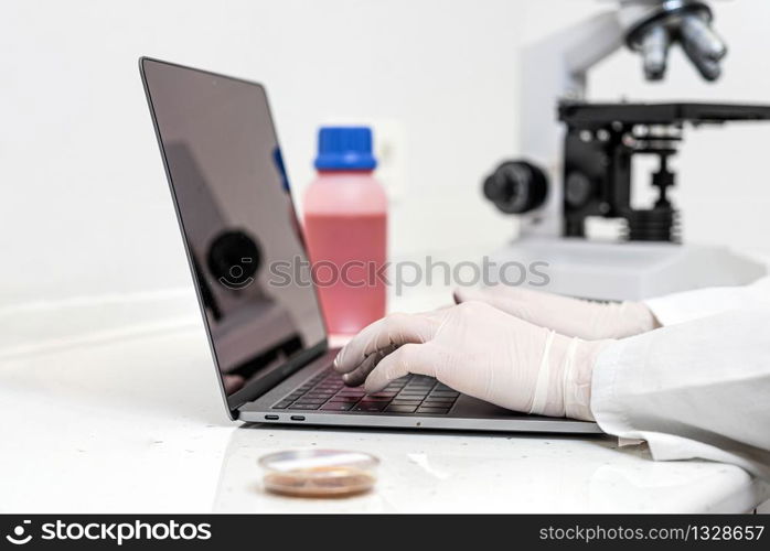 Corona virus Covid-19 research. Scientist working on laptop searching for vaccine. Doctor gets ready to fight coronavirus outbreak, searching for cure .. Corona virus Covid-19 research. Scientist working on laptop searching for vaccine. Doctor gets ready to fight coronavirus outbreak, searching for cure.