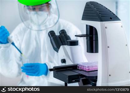 Corona Virus Vaccine Research, Scientist Working in the Laboratory, Looking Through the Microscope