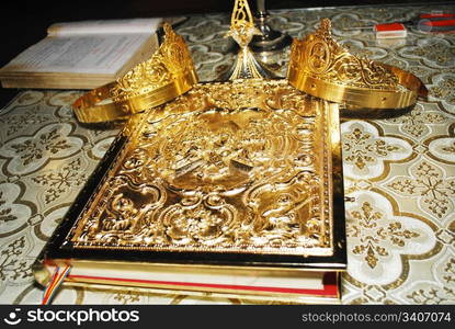 Coronation crowns, cross,chalice and bible on the table in church