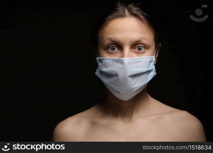 coronavirus, a girl in a mask on a black background. Title about the outbreak of the corona virus, illness. Epidemic. coronavirus, a girl in a mask on a black background. Title about the outbreak of the corona virus, illness. Epidemic.