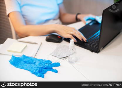 Coronavirus concept. Woman in quarantine for coronavirus covid-19 working from home. Protective mask and Sanitizer spray on the working place. working from home