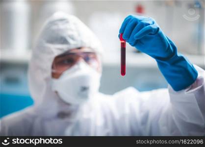 coronavirus covid-19 blood test concept, 2019-nCoV virus checking in medical laboratory with blood test tubes, researcher holding blood s&le for testing in hospital lab