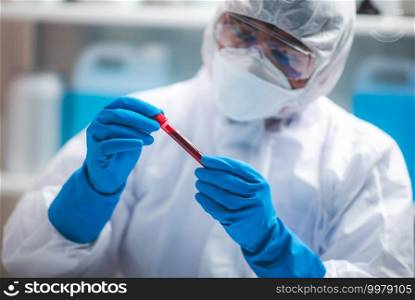coronavirus covid-19 blood test concept, 2019-nCoV virus checking in medical laboratory with blood test tubes, researcher holding blood s&le for testing in hospital lab