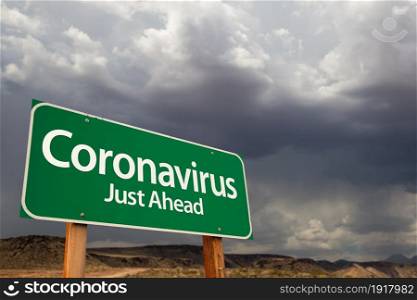 Coronavirus Green Road Sign Against Ominous Stormy Cloudy Sky.