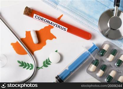Coronavirus, nCoV concept. Top view of a protective breathing mask, stethoscope, syringe, pills on the flag of Cyprus. A new outbreak of the Chinese coronavirus. Coronavirus, nCoV concept. Top view of a protective breathing mask, stethoscope, syringe, pills on the flag of Cyprus.