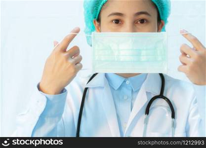 Coronavirus stop infection. young female doctor wearing mask with stethoscope against infectious diseases and flu. Healthcare concept