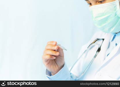 Coronavirus stop infection. young female doctor wearing mask with thermometer and stethoscope against infectious diseases and flu. Healthcare, medical education, emergency medical service, surgery concept