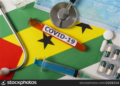 Coronavirus, the concept COVid-19. Top view protective breathing mask, stethoscope, syringe, pills on the flag of Sao Tome and Principe. A new outbreak of the Chinese coronavirus. Coronavirus, the concept COVid-19. Top view protective breathing mask, stethoscope, syringe, pills on the flag of Sao Tome and Principe.