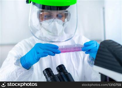 Coronavirus Vaccine Research. Scientist in Protective Suit Researching Virus Antibodies, Developing a Vaccine