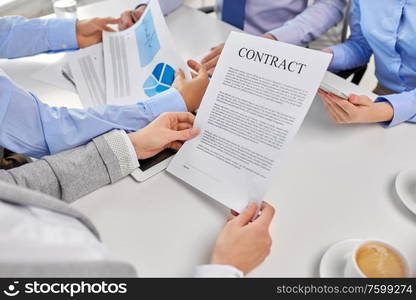 corporate and people concept - close up of business team with charts and contract at office. close up of business team with charts and contract