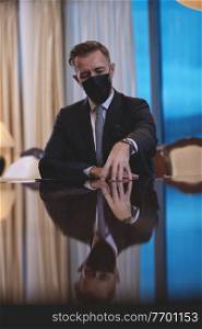 corporate business man wearing protective medical face mask at luxury office