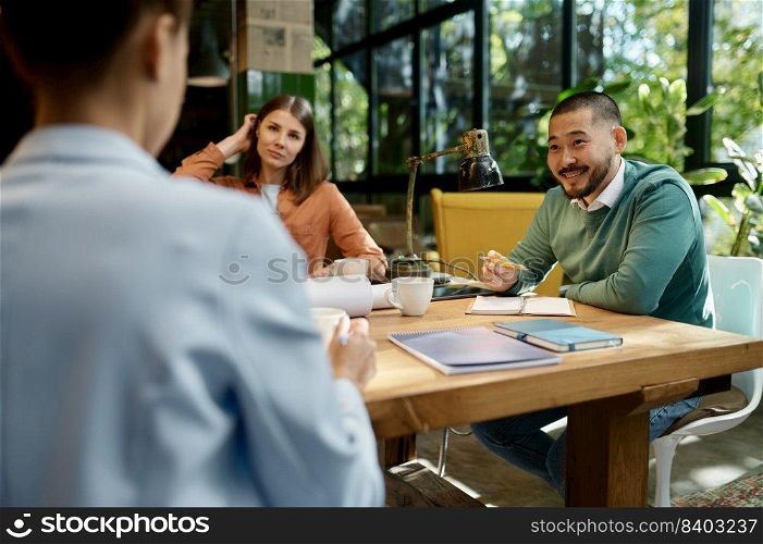 Corporate business team discussing startup project ideas on meeting in eco-friendly coworking space. Business team discussing startup project ideas on meeting in coworking space
